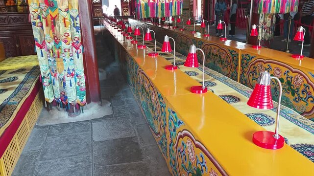 Beijing, China - May 10, 2026: Yunhegong Tibetan Buddhist Temple, Lamaist Temple. Colorful interior of Yunhegong Tibetan Buddhist Temple with red lamps and decorative seating in a serene environment