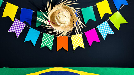 Brazilian June festival decoration. Colorful flags, straw hat and Brazilian flag.