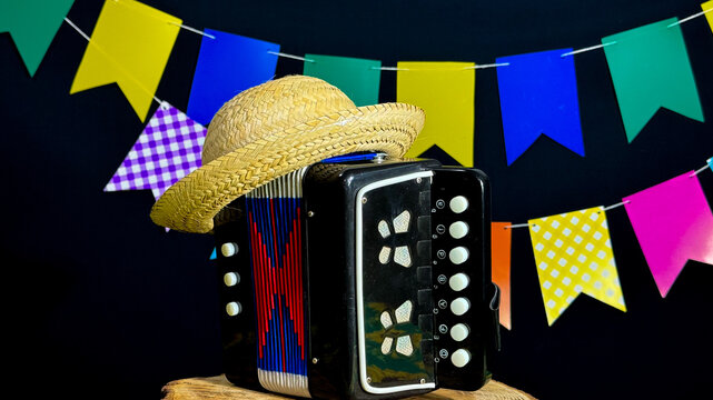 Brazilian June festival decoration. Colorful flags, straw hat and accordion.