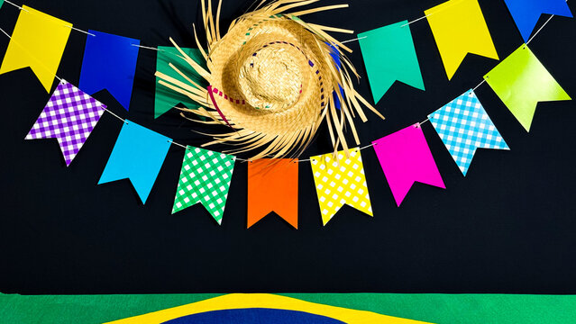 Brazilian June festival decoration. Colorful flags, straw hat and Brazilian flag.