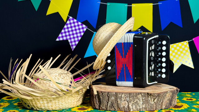 Brazilian June festival decoration. Colorful flags, straw hat and accordion.