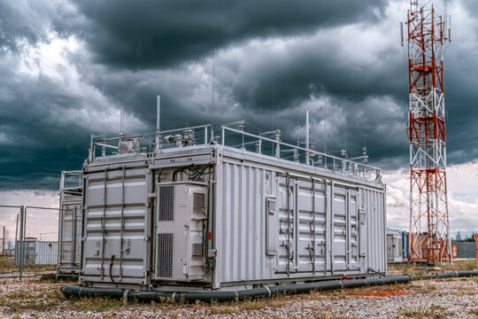 Industrial Data Center Containers Under Stormy Sky With Antenna