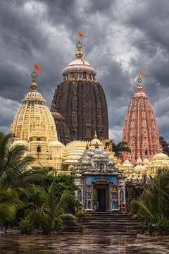 Majestic ancient stone temple architecture under dark cloudy skies preparing for the traditional ratha yatra and sacred jagannath ratha yatra puja ceremony with beautiful shrines