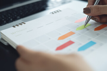 Closeup, woman hand writing on 2026 calendar event planner to set timetable organize schedule, event planning for business meeting or vacation plan. business planning concept. © tippapatt