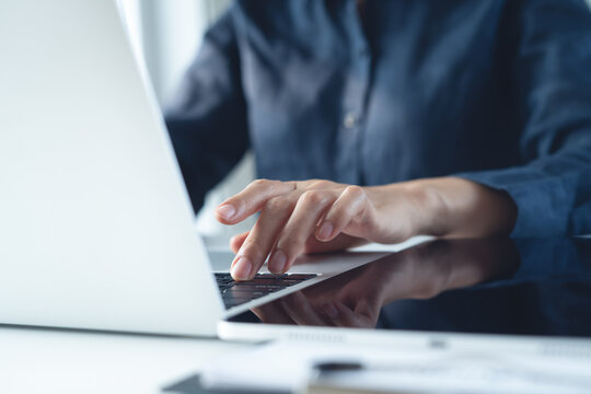 Close up, business woman working on laptop computer, surfing the internet, searching the information with digital tablet on table office. business technology, online working