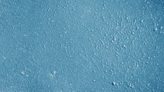 Bubbles in light blue liquid macro motion background, abstract water bubbles moving upwards, clean pure aqua background, gas bubbles in water.