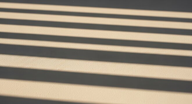 Abstract parallel shadow lines cast on a light beige texture