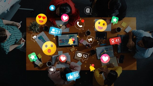 Engaging Team Meeting with Social Media Reactions and Digital Interaction Symbols Overhead View of Diverse Group Collaborating on Project Gluon.