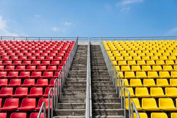 Fototapeta premium Empty stadium seating providing red and yellow plastic rows