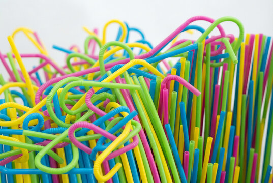 Colorful bendy plastic drinking straws gathered in a large cluster