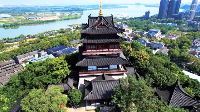 Traditional pagoda overlooking river and modern skyline
