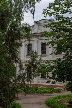 Historic pre-revolutionary lyceum building framed by green trees