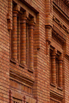 Detailed brickwork pattern with pilasters and corbels on historic wall 