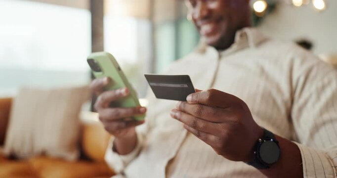 Hands, phone or black man with credit card for online shopping, payment or purchase in home. Happy, male person or shopper with smile, debit or smartphone for ecommerce or mobile banking app in house