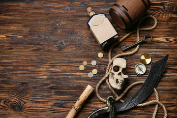 Pirates items on wooden background, top view © Pixel-Shot