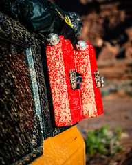 Muddy red fuel containers on an offroad vehicle © Cavan
