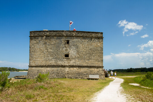 Visitors exploring a historic coastal stone fort