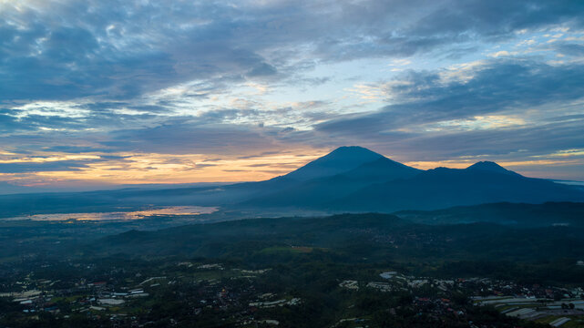 Beautiful Aerial Sunrise View of Mount Merbabu and Rawa Pening Lake with Dramatic Clouds, Central Java, Indonesia