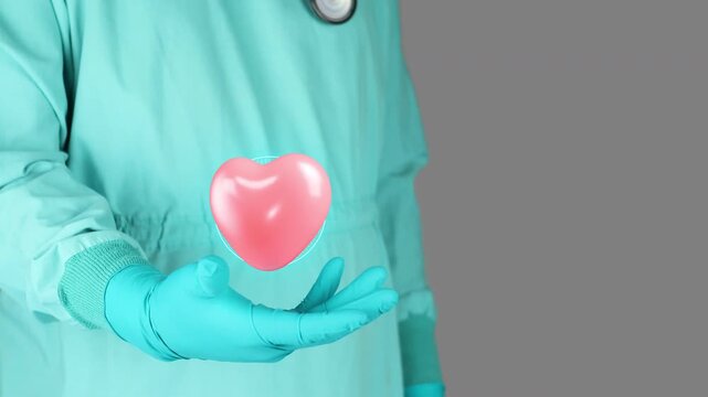 Doctor in green uniform presents the 3D heart symbol. Concept of public health, family medicine, regular check-ups, health prevention and awareness, malnutrition and metabolic risk factors.