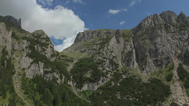 Faster ascending drone flight over the dramatic glacial cirque edge in Valea Gaura, Bucegi mountains, Romania, a sweeping alpine panoramic view