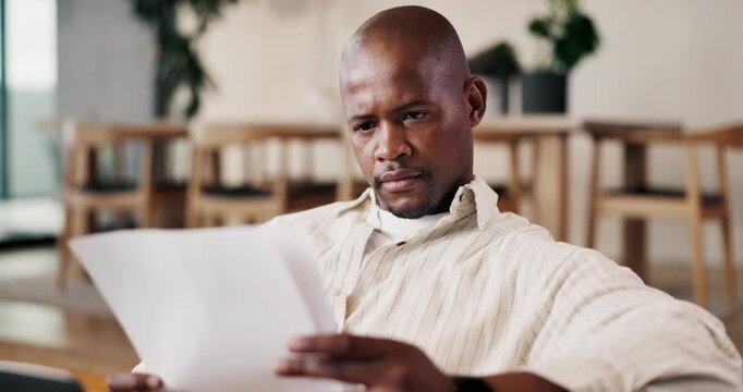 Review, paperwork and black man with remote work in home, proofreading story and check chapter draft. Serious, freelancer and editor with plot analysis for narrative development, laptop and proposal