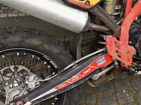 Dirt bike rear wheel and exhaust system in detail. Enduro Race World