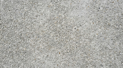 Fototapeta premium Pebble Texture Background: A close-up, overhead view of a surface covered in small, grey and white pebbles, creating a natural, granular texture.