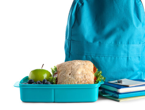 Backpack, stationery and lunchbox with yummy food isolated on white background