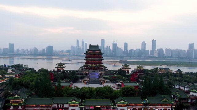 Tengwang Pavilion and Nanchang Skyline Across the Gan River at Sunset in Tengwang Pavilion, Nanchang, Jiangxi, China