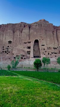 The breathtaking Bamyan Valley in central Afghanistan, home to the ancient Buddhas carved into the cliffs. A historical UNESCO World Heritage site surrounded by dramatic mountains, cultural heritage,