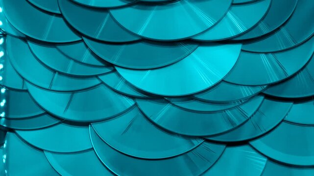 Reflection of the surface of a DVD discs, multiple optical discs stacked on top of each other like fish scales, colorful lines on the surface are caused by thin-film interference and diffraction