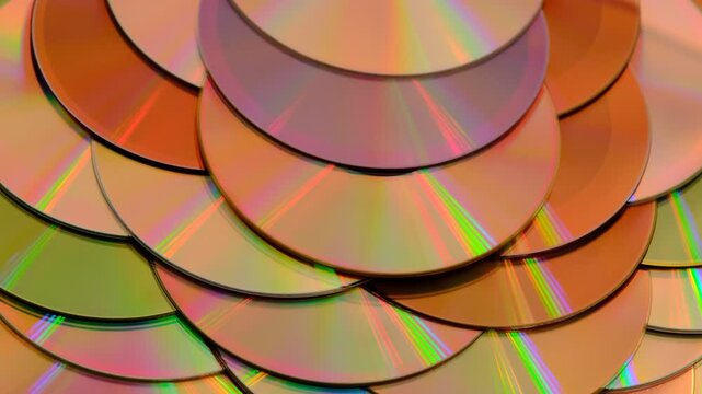 Reflection of the surface of a DVD discs, multiple optical discs stacked on top of each other like fish scales, colorful lines on the surface are caused by thin-film interference and diffraction