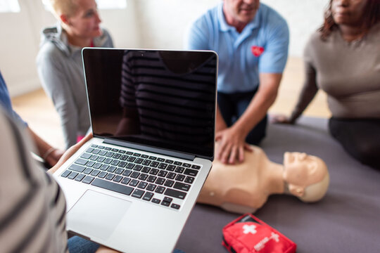 CPR training with laptop guidance.