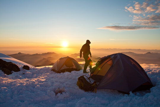 Alpine start - Climber awake at sunrise to prepare for summit push