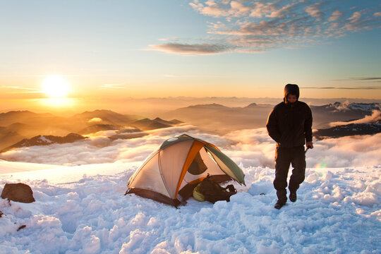 Mountaineer exits tent on mission for mountain summit