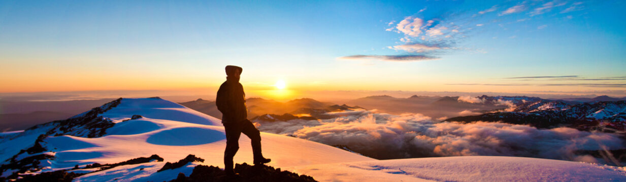 Silhouetted man in warm clothing on Mount Baker glacier