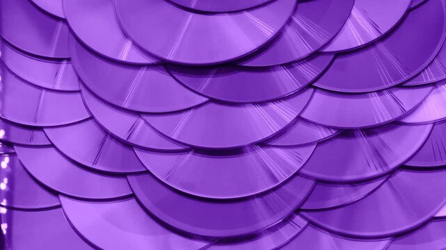 Reflection of the surface of a DVD discs, multiple optical discs stacked on top of each other like fish scales, colorful lines on the surface are caused by thin-film interference and diffraction