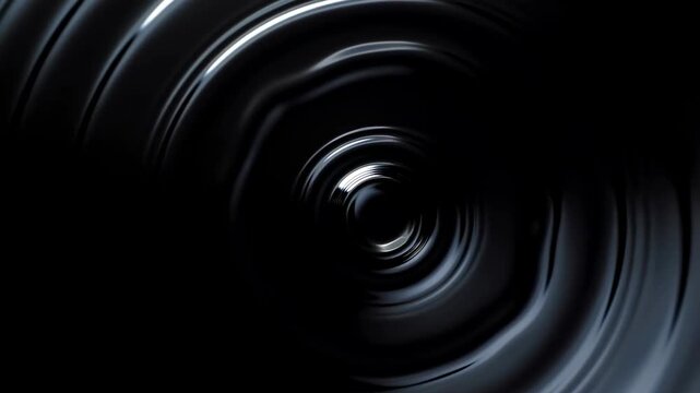 Slow motion tracking zoom closeup of black liquid vortex rotating and spiraling into center on dark studio background with reflective sheen