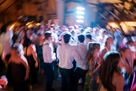 Energetic Blurred Party Crowd Dancing Indoors
