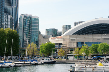 Naklejka premium Toronto, Canada - May 26, 2026: Rogers Centre and Waterfront Marina with Modern High Rise Buildings