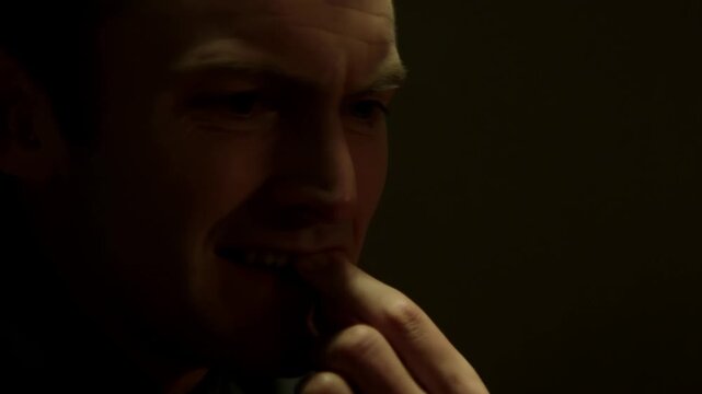 Thoughtful man in deep contemplation with dramatic lighting in closeup