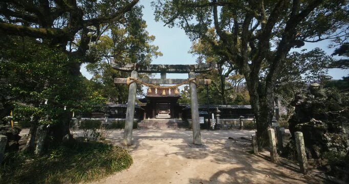 Stone Torii Gate and Shrine in Hiroshima Japan, steady cam forward shot