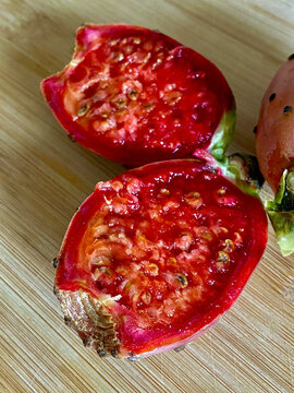 Red prickly pear on a wooden cutting board. Close up.