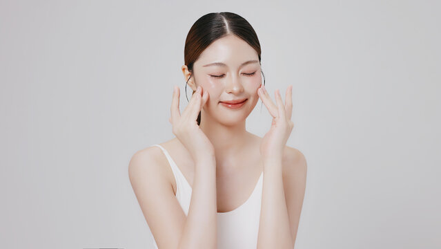 Studio shot of Beautiful young Asian woman with clean fresh skin, Face care, Facial treatment, Cosmetology, beauty and spa.