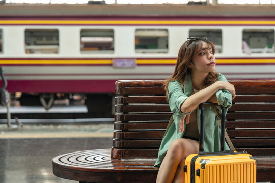Young woman depressed mistakes a train. Female backpacker Traveler waiting at train station. Boarding the wrong ticket feeling stressed. Planning Fail trip tourist missing