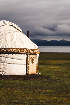Traditional Kyrgyz Yurt Glowing in Evening Light by Lake