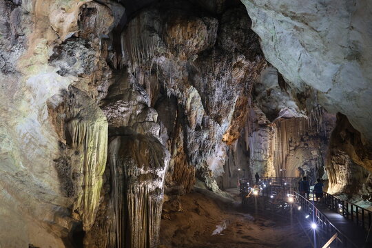 Dramatic Illuminated Cave Chamber with Flowstone and Walkway Phong
