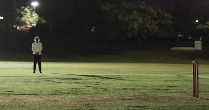 Teenage batsman after delivery swinging, running, teammate stepping consoling at stumps at park
