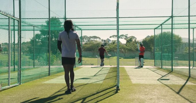 Indian male bowler jogging into a3 lane practicing underarm bowls to nets, teenage player charging