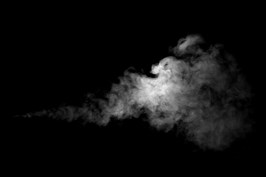Isolated white smoke plume or steam cloud on black background. Realistic soft smoke trail for digital design, motion graphics, compositing, and creative visual effects overlay.